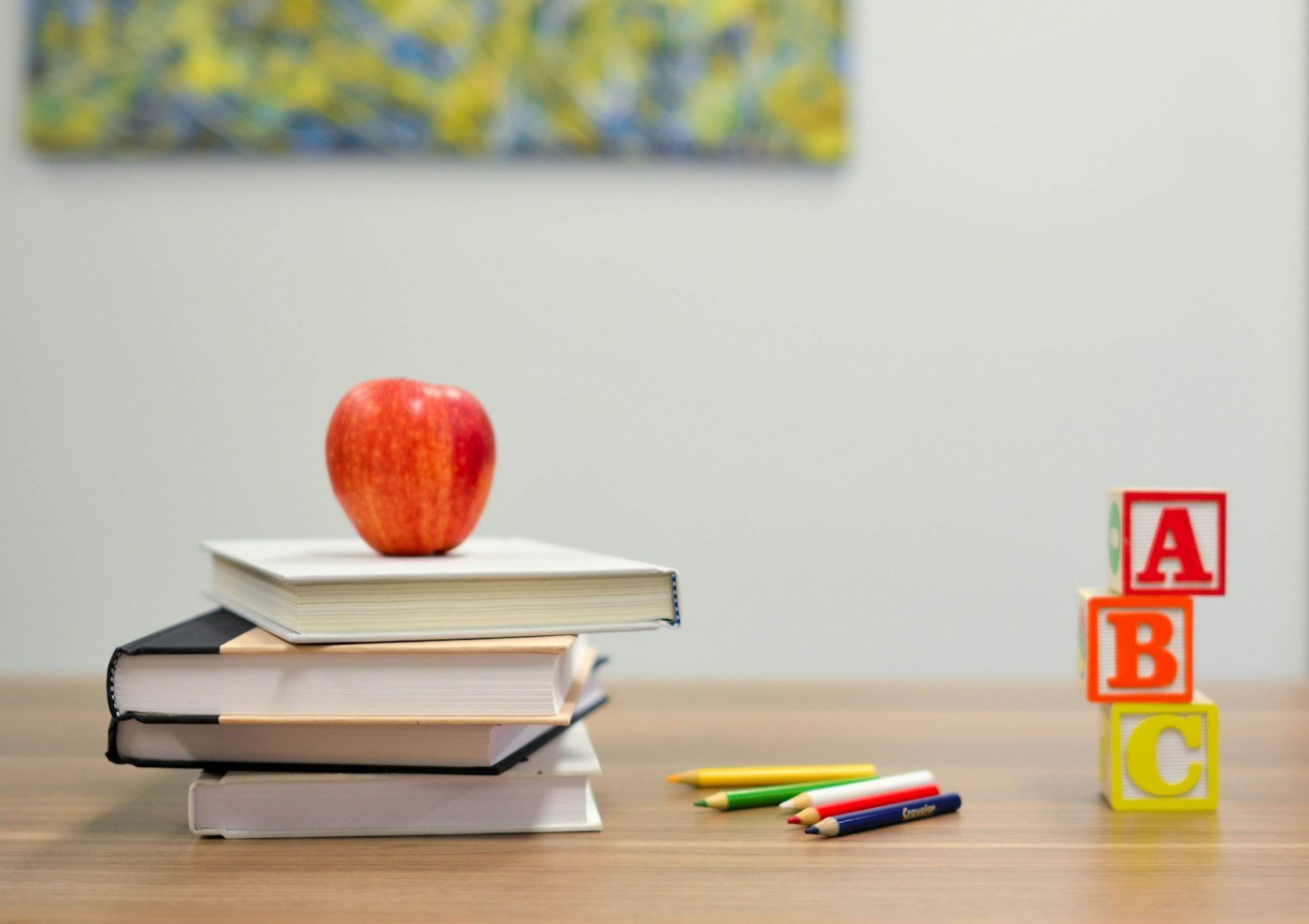 A classroom desk with books and a notebook.